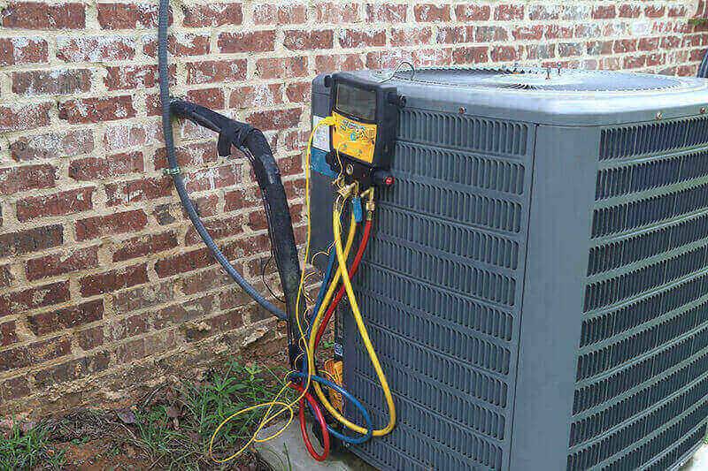An air conditioner connected wires and a hose